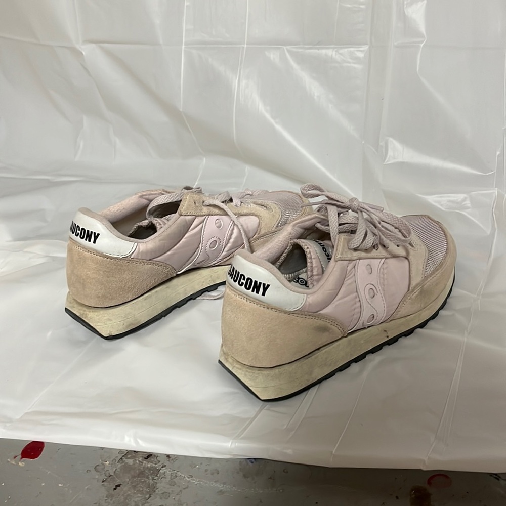 Pink and beige sauconys with black bottoms